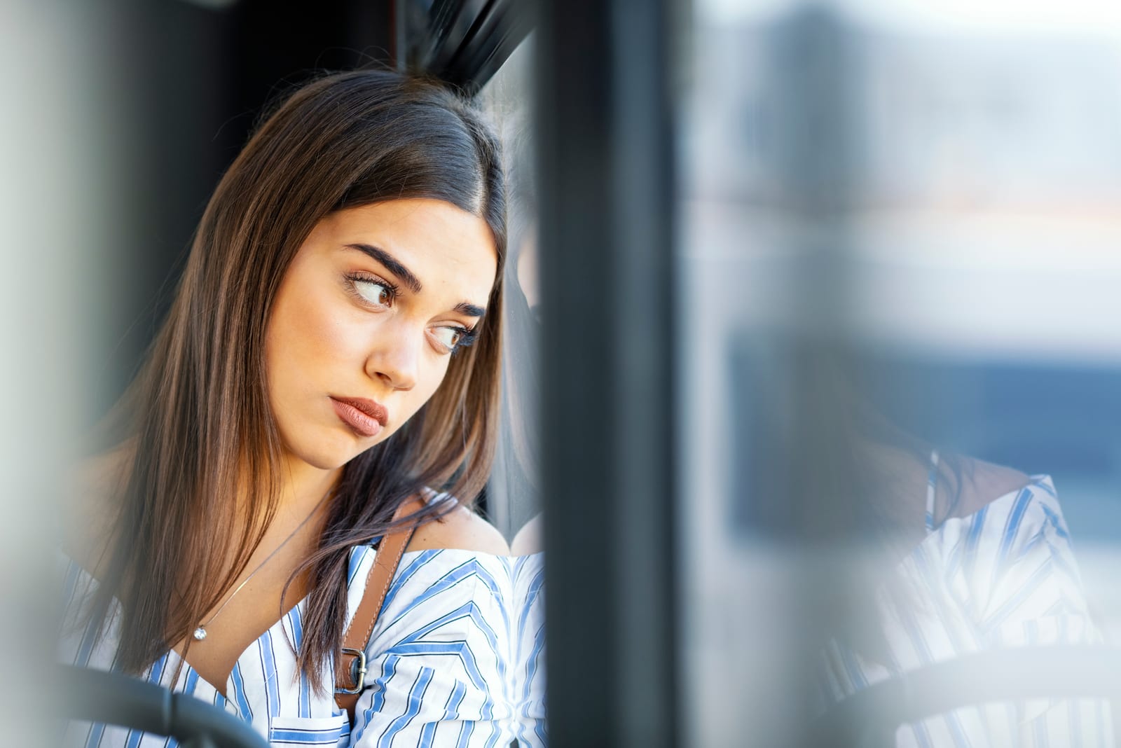 woman in train looking through the window