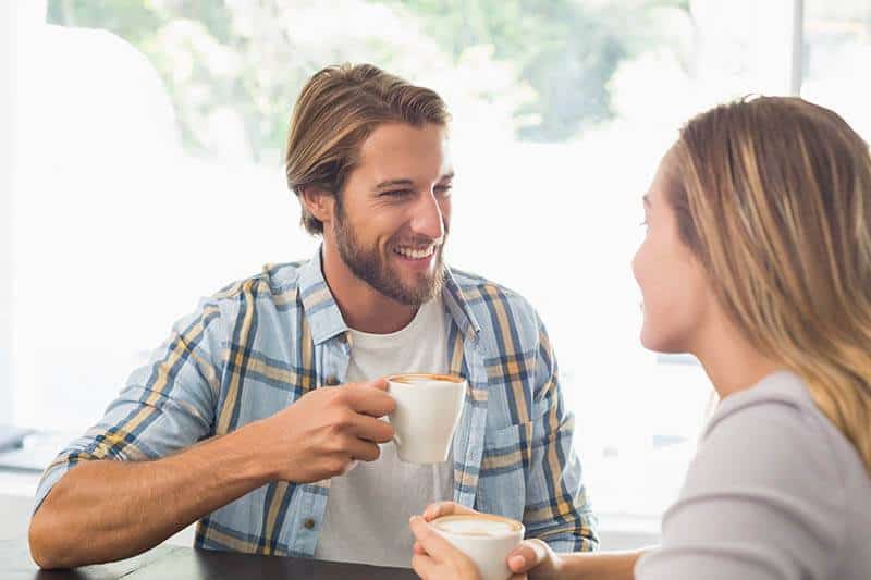 Happy couple enjoying a conversation over coffee