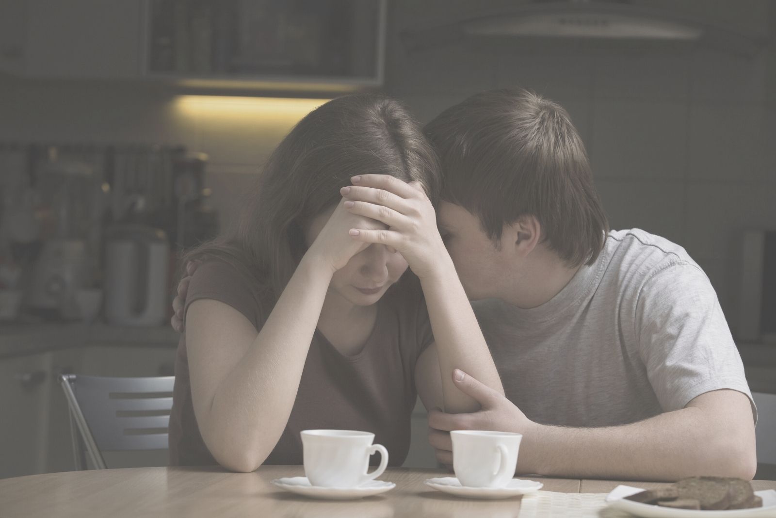 young man consoling woman with a problem in the dining room 