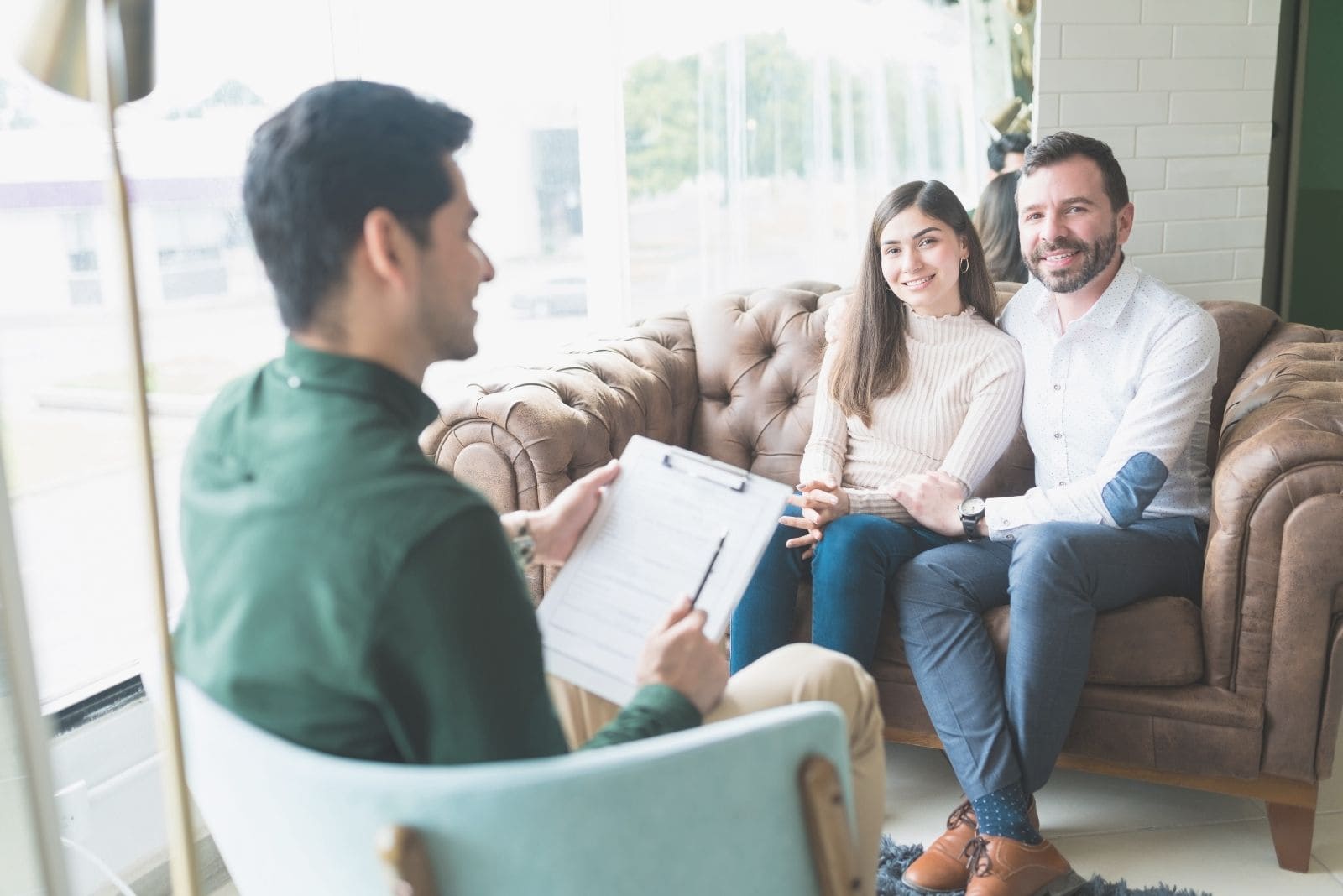 reconciled couple visiting marriage counsellor in a therapy session
