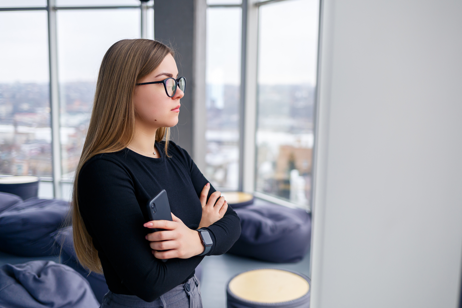 photo of a woman standing in a bright apartment