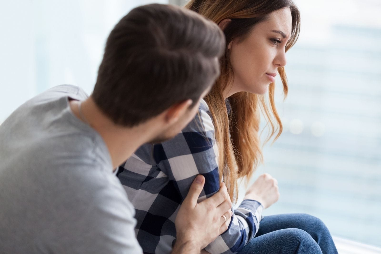 young man helping a woman emotionally down by talking to her