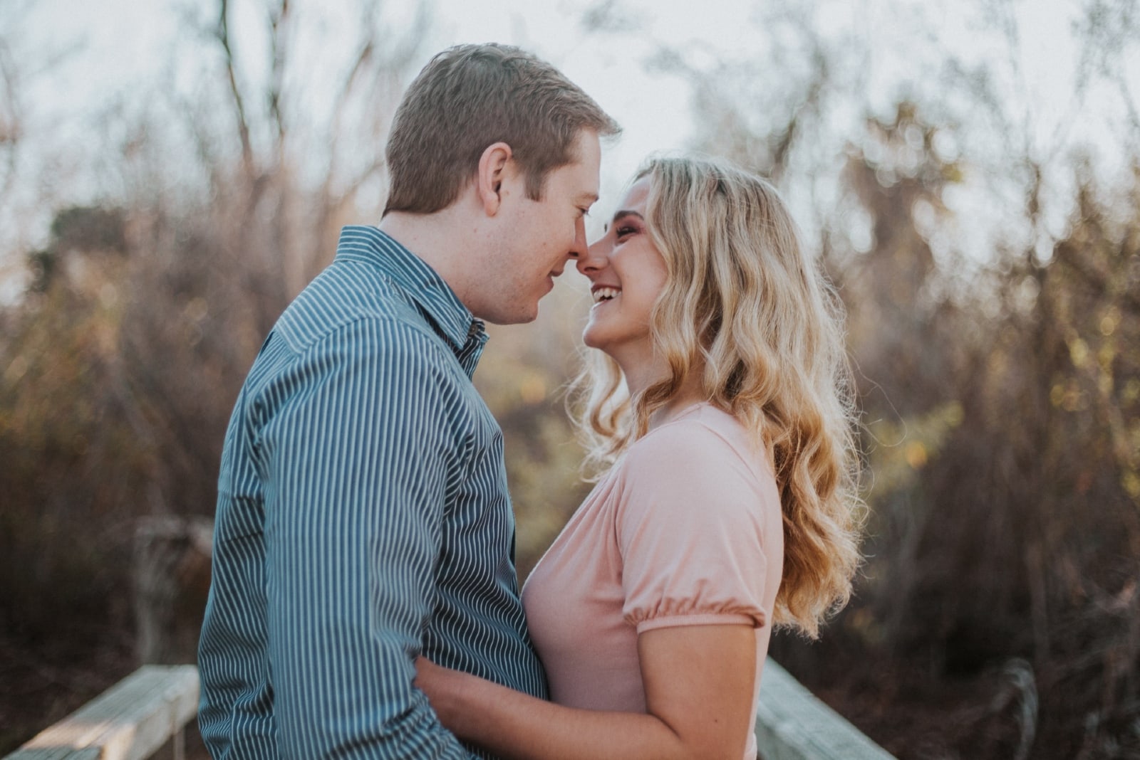 man and woman about to kiss while standing outdoor