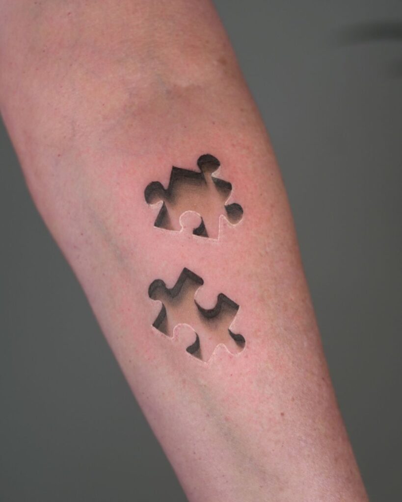 Engraved Puzzle Pieces Tattoo