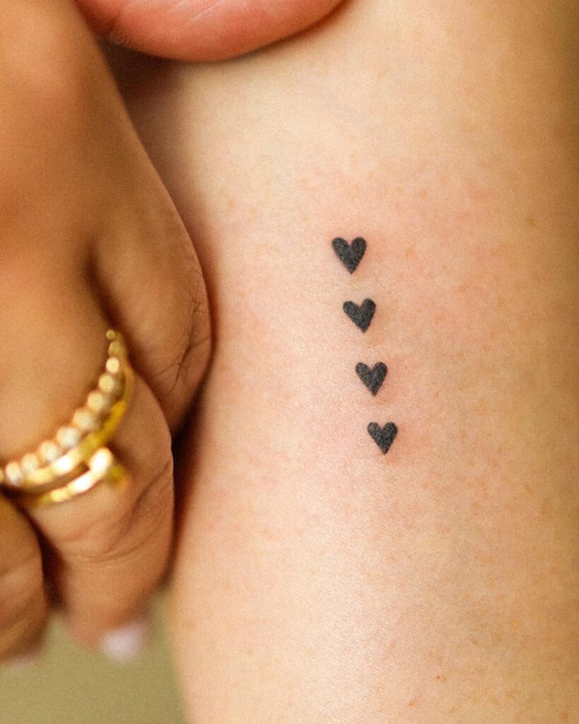 Four Micro Hearts Tattoo