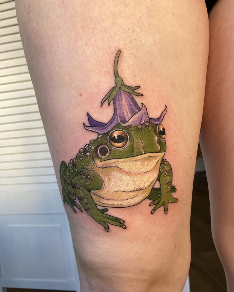 playful frog with an eggplant leg tattoo