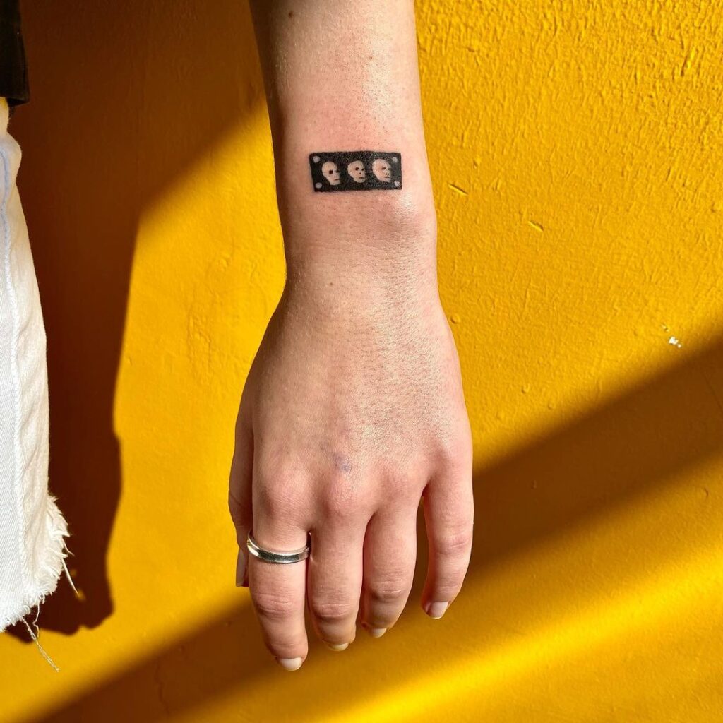 small skull wrist tattoo