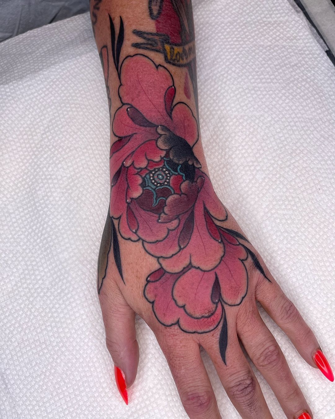 vibrant flower hand tattoo