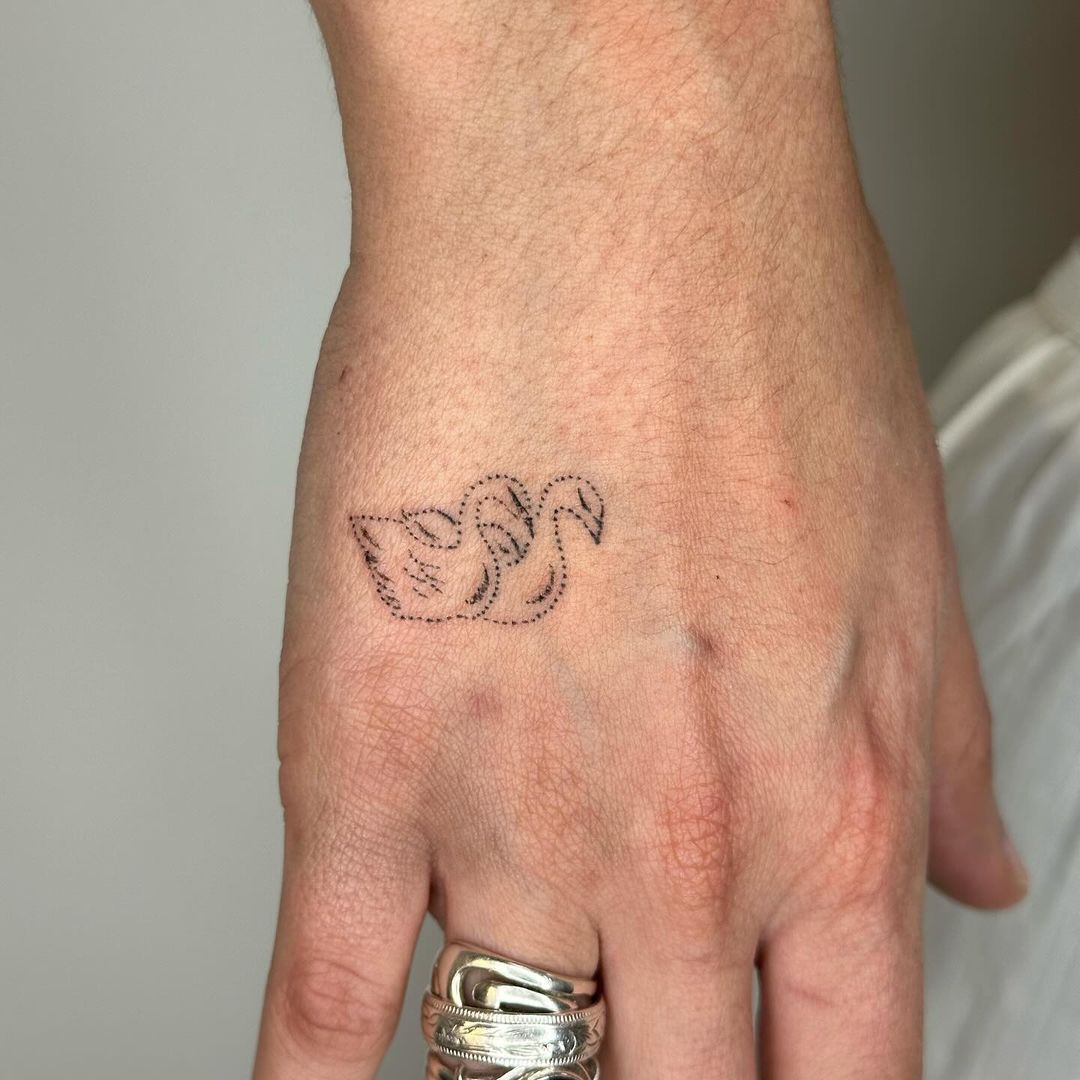 adorable swan hand tattoo