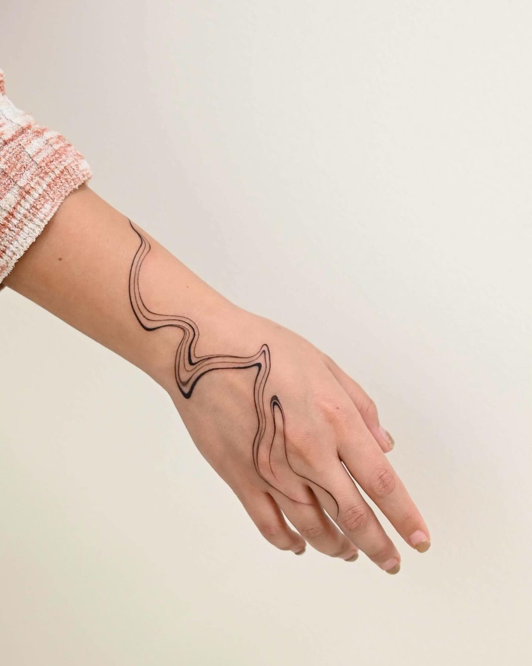 flowing hand tattoo