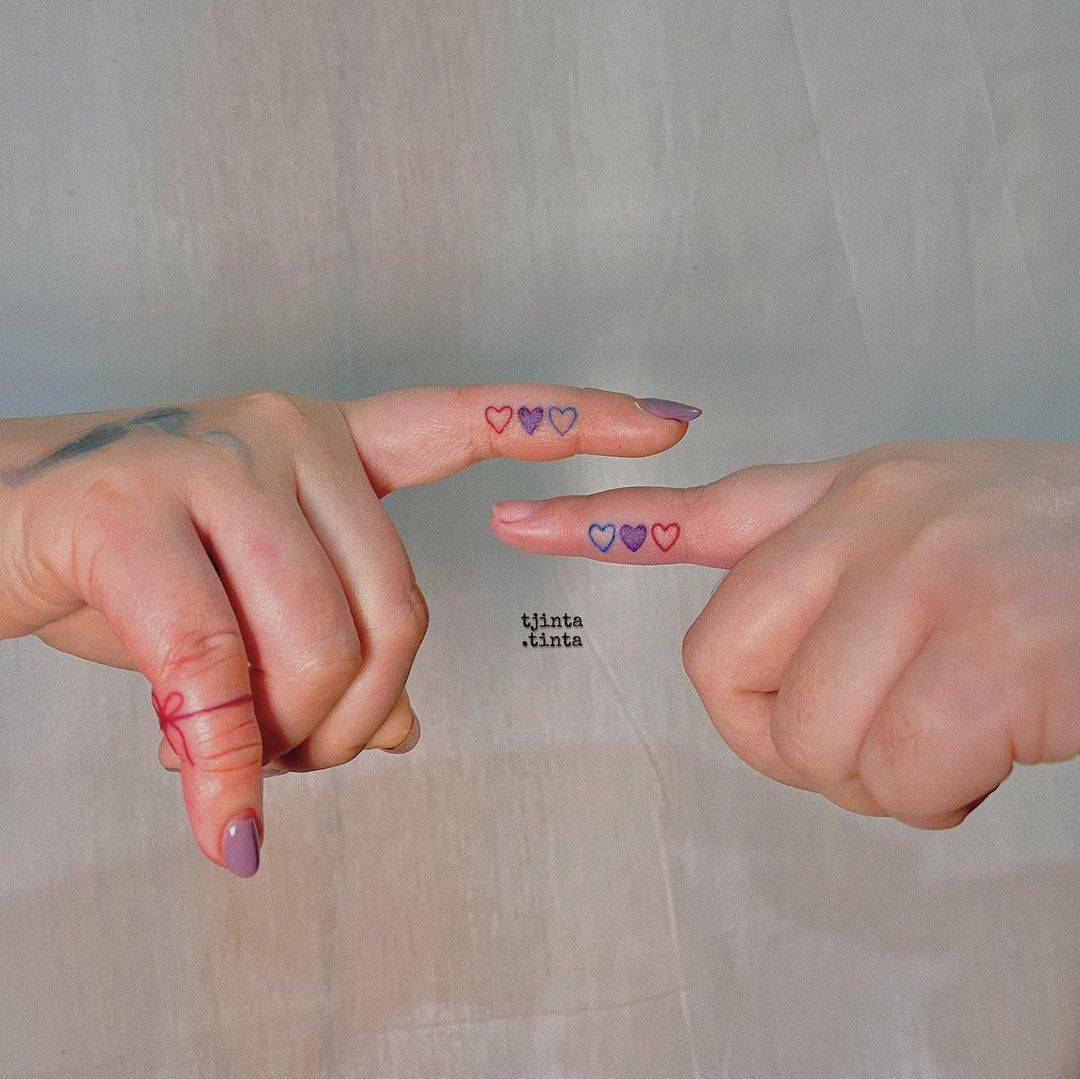 Hearts matching finger tattoos for girlfriends