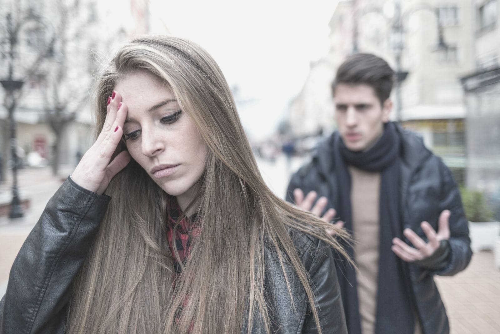 young couplw breaking up in the street woman leaving the man