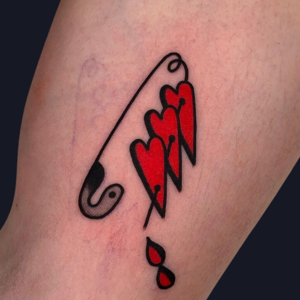 Safety Pin Piercing Three Red Hearts Tattoo