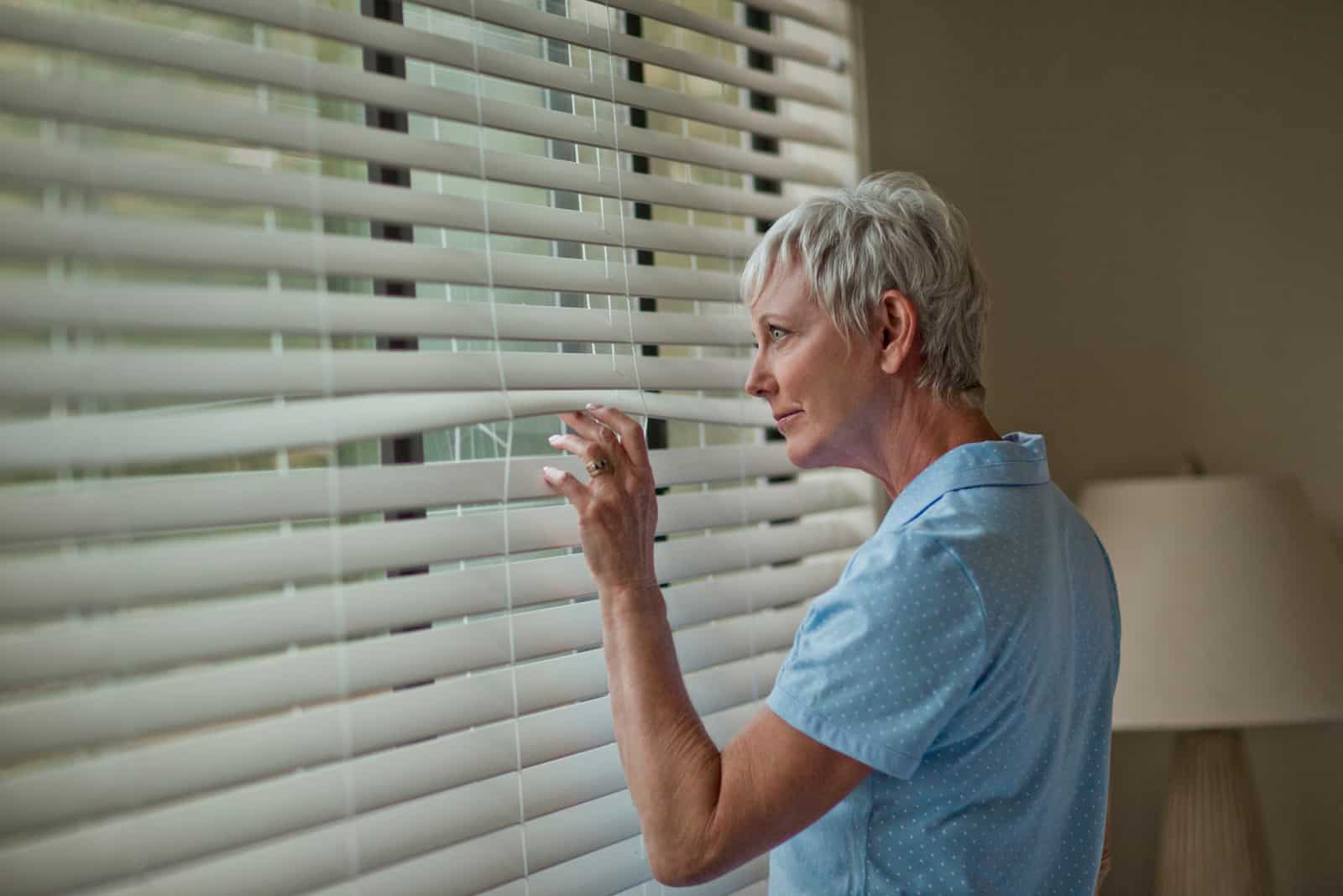 woman peeking at her neighbors