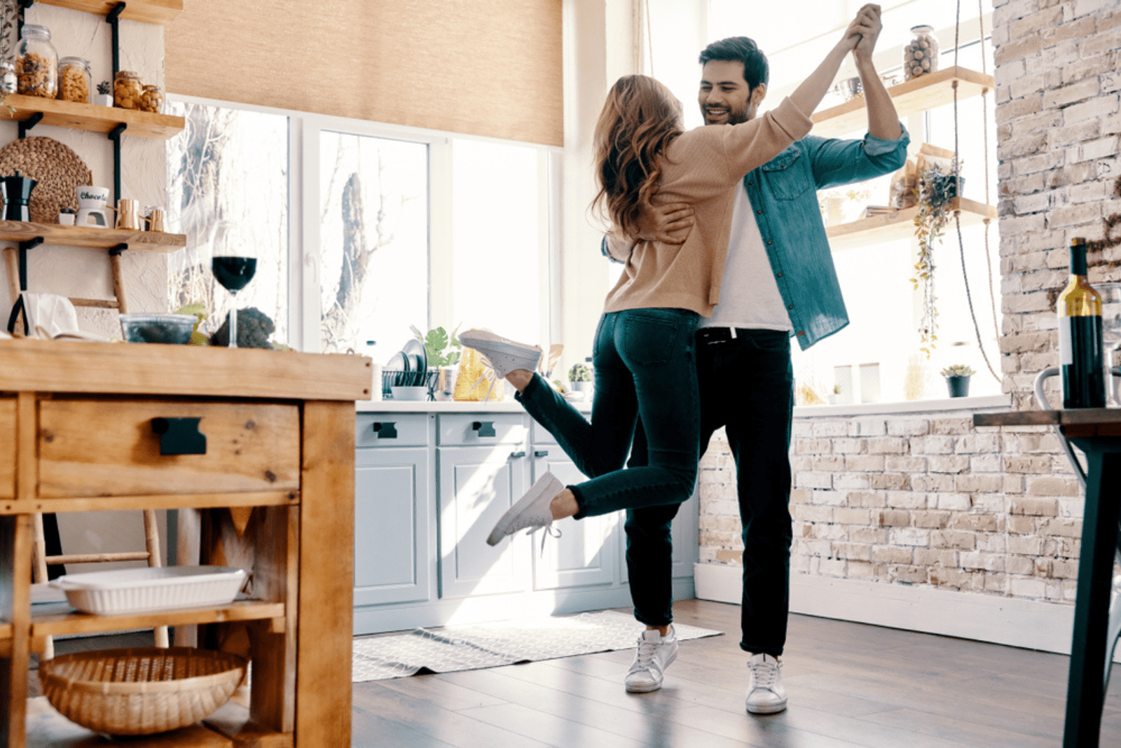 a loving couple dancing in their home