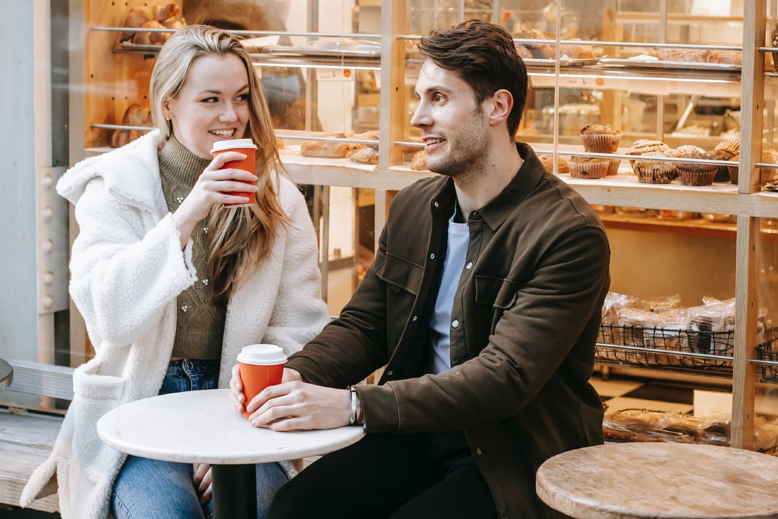 man and woman enjoying coffee outdoors