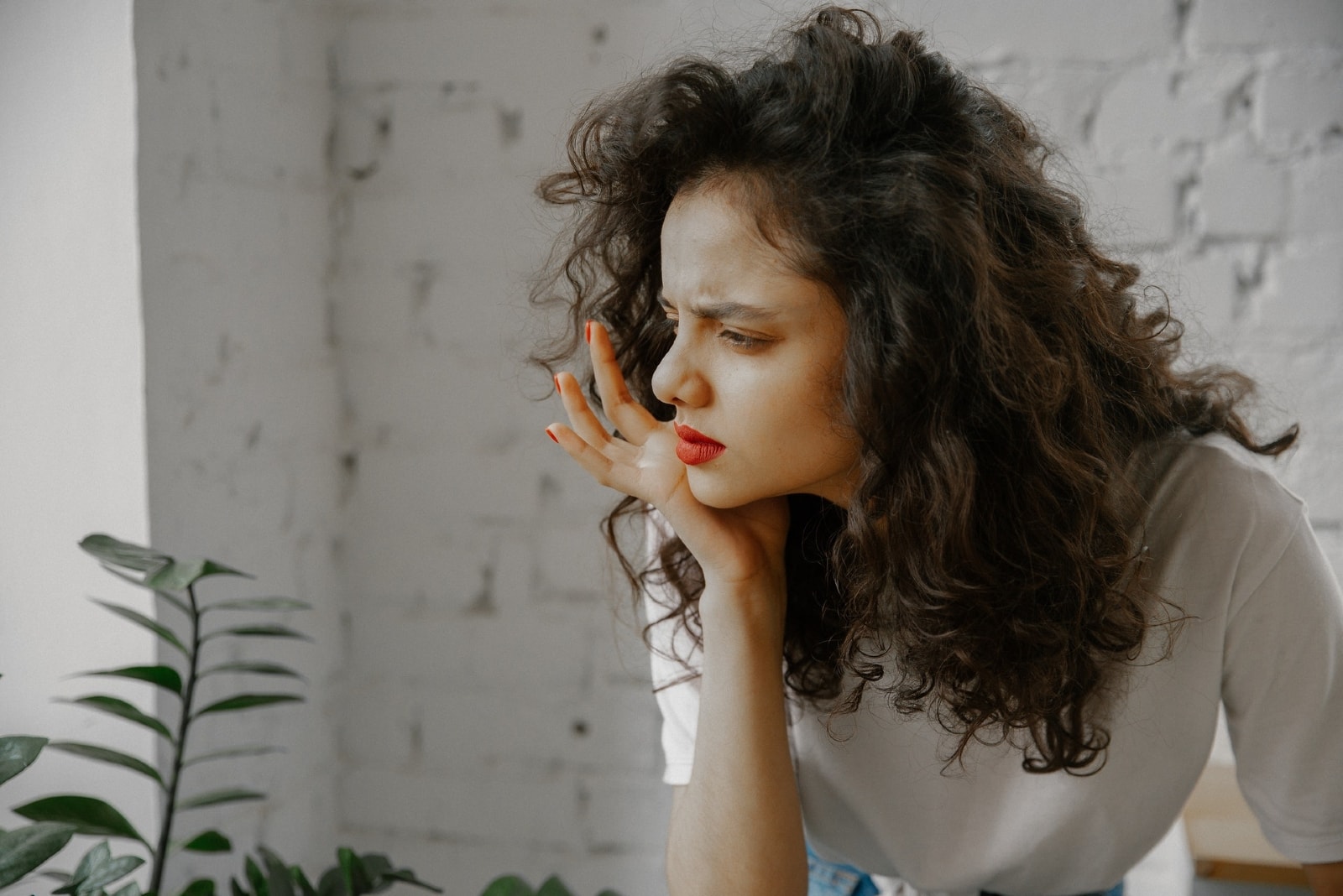 woman in white t-shirt thinking indoor